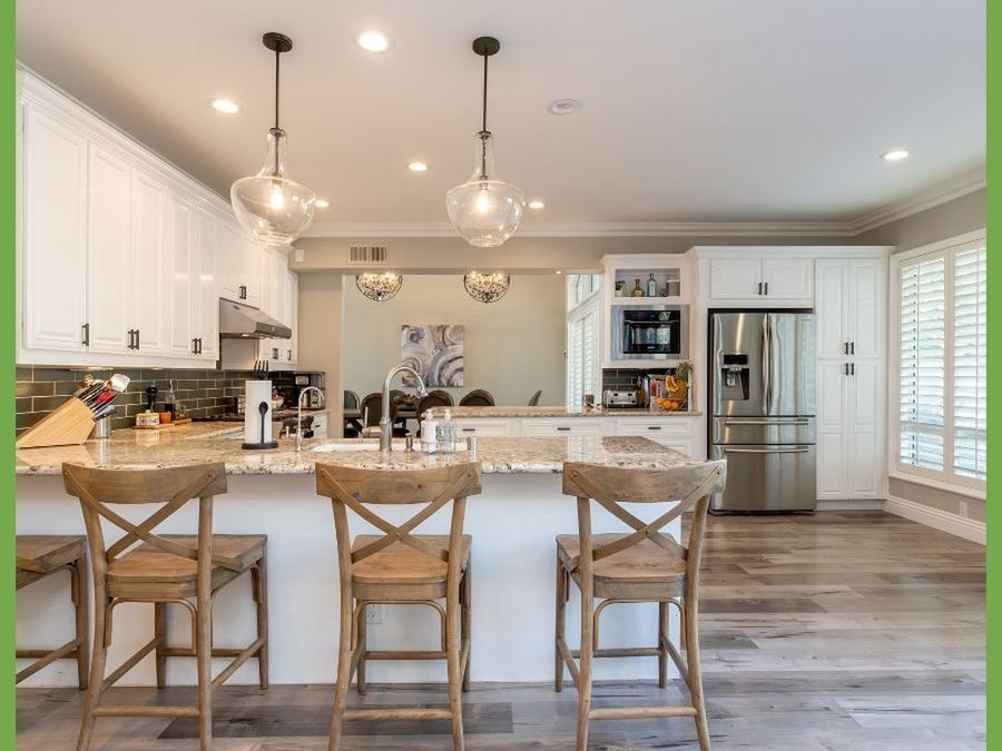 Bright kitchen with an island and three stools